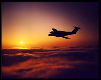 Air-to-air photo at sunset of a Beechcraft Duchess over Santa Cruz, CA