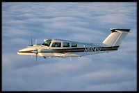 Air-to-air photo of a Beechcraft Duchess over Santa Cruz, CA