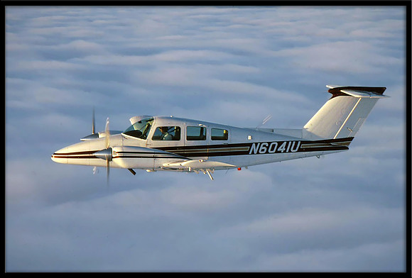 Air-to-air photo of a Beechcraft Duchess over Santa Cruz, CA